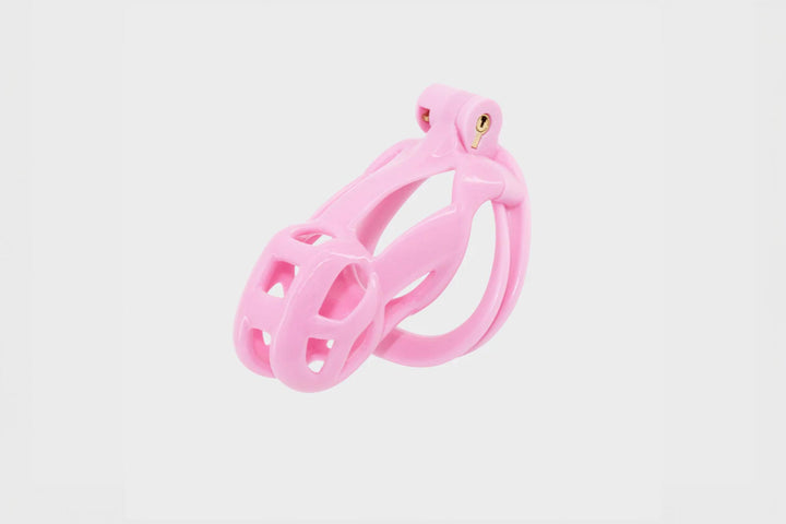 A pink Cobra chastity cage made from hard resin.