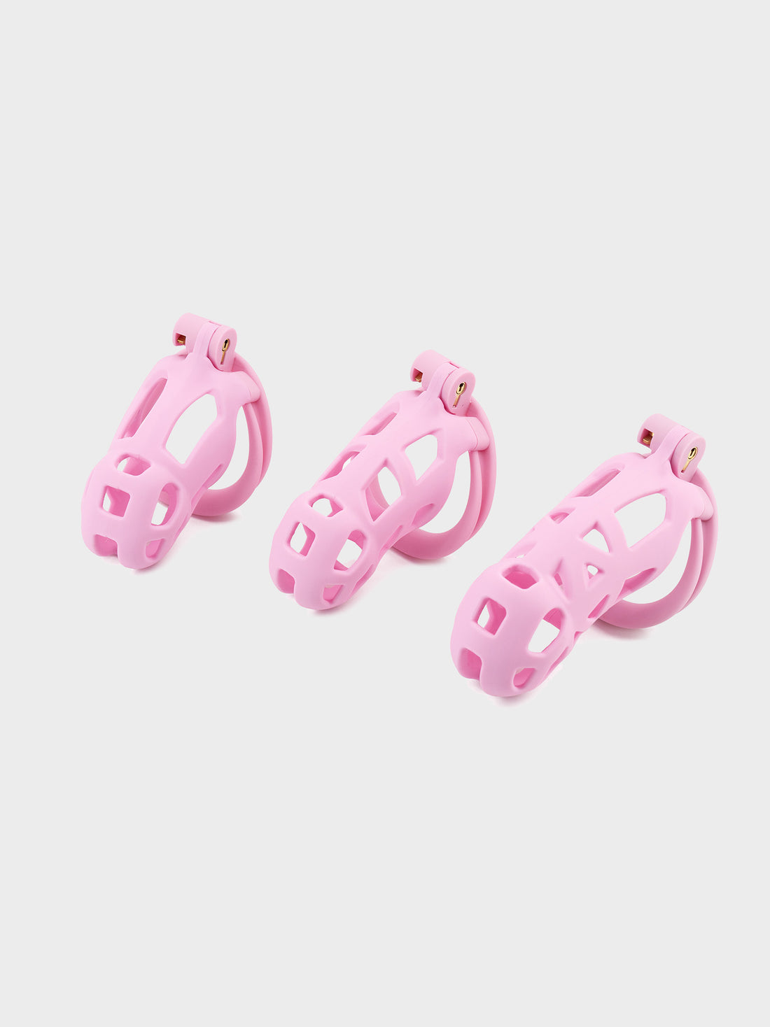 medium to large pink cobra chastity cages compared in size.