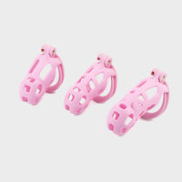 medium to large pink cobra chastity cages compared in size.