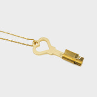 A chastity key and lock on a chain.