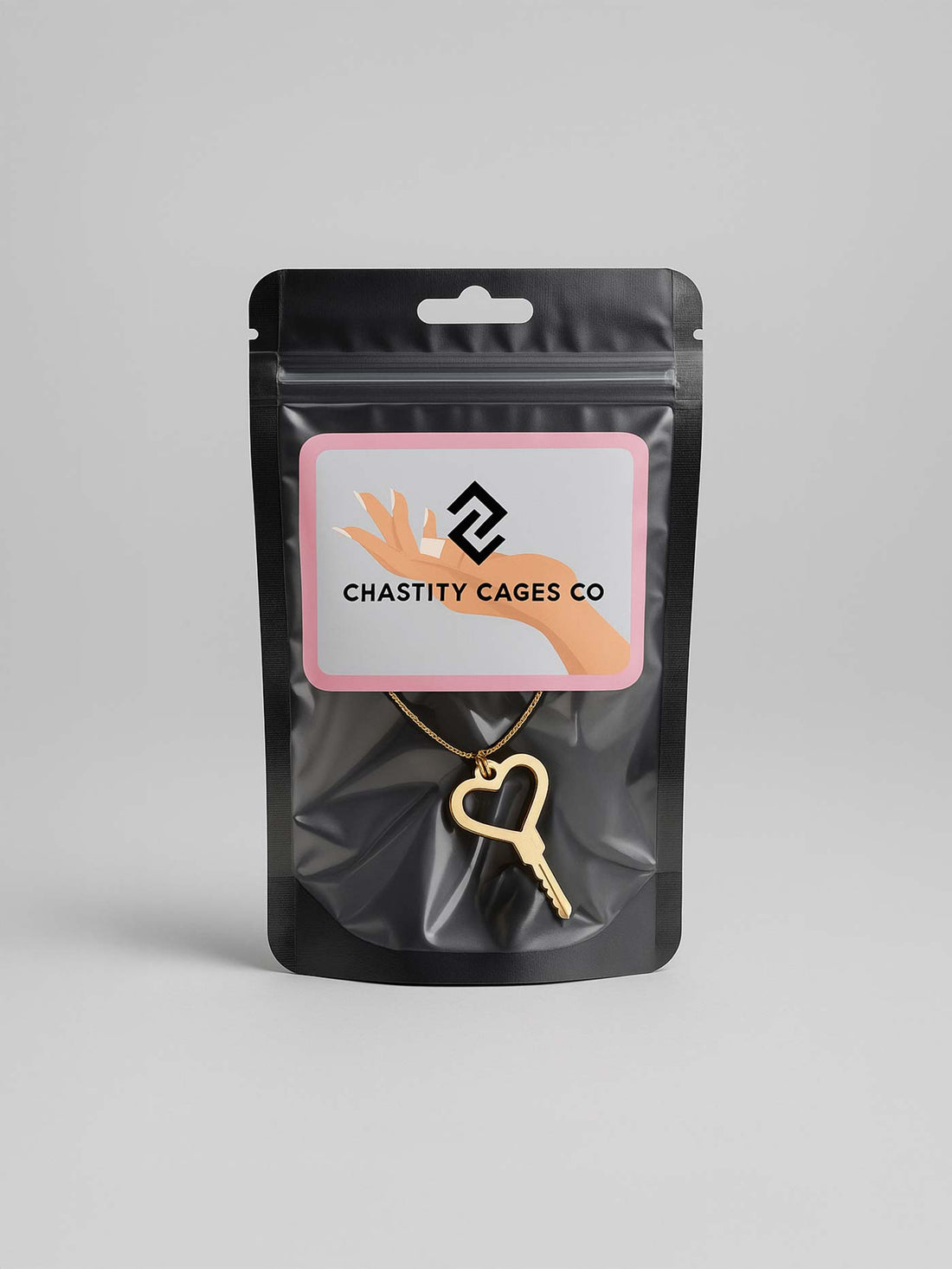 Black packaging with a gold key pendant and &
