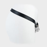 A short steel chastity cage mounted on a black leather belt.