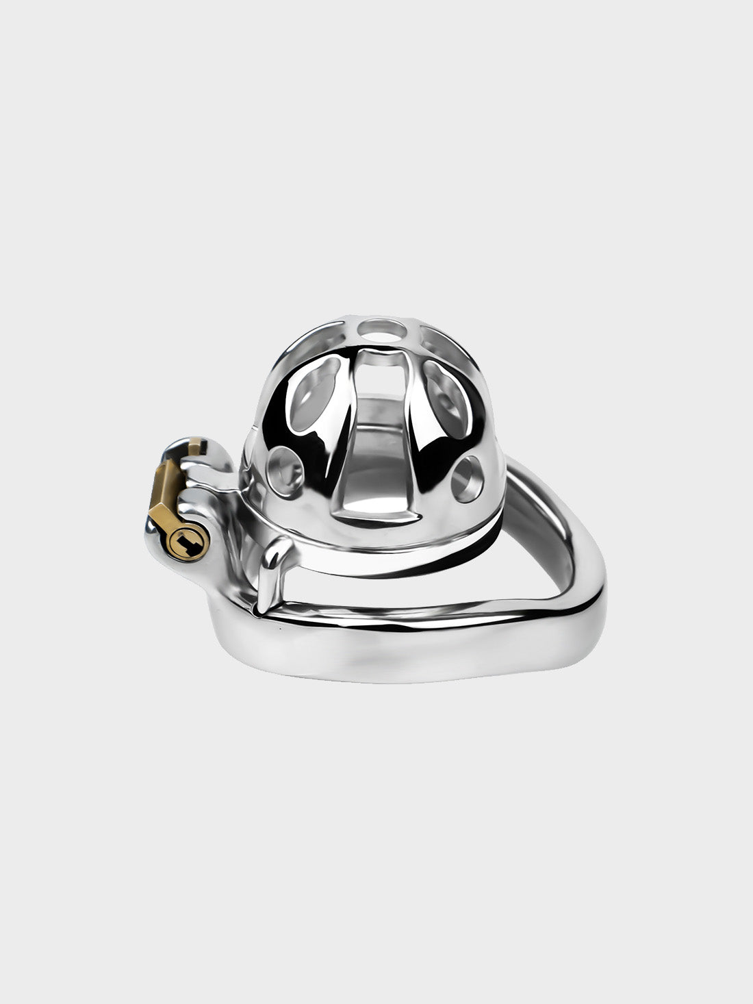 A tiny locked chastity cage made from steel sits on a neutral background.