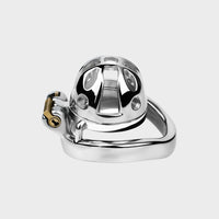 A tiny locked chastity cage made from steel sits on a neutral background.